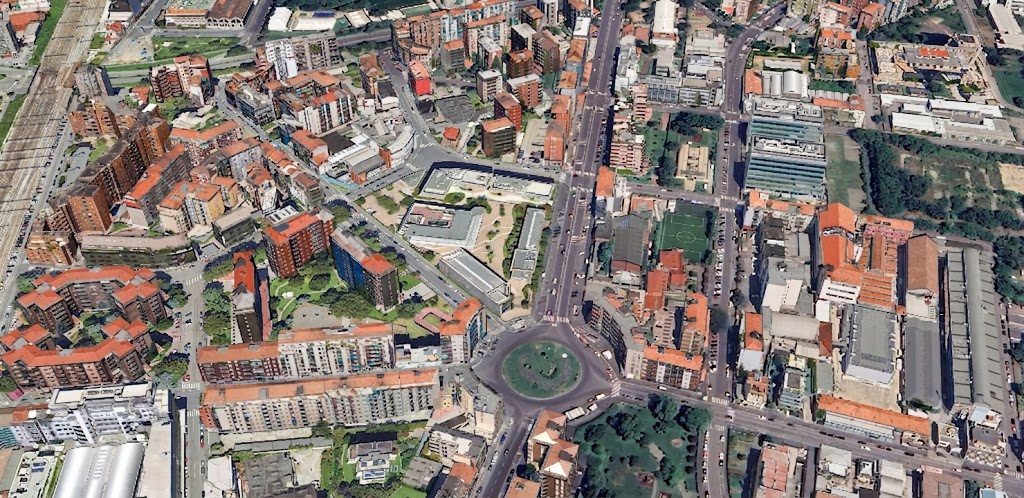 Milan Metro Complex — angular stone-and-glass massing on the corner